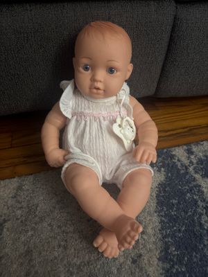 Baby doll wearing white onesie
