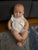 Baby doll wearing white onesie