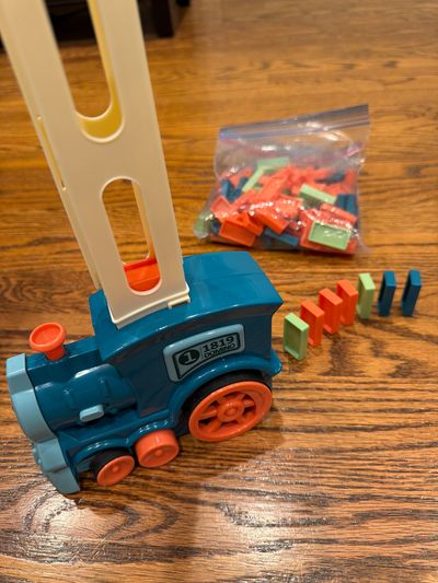 Domino train automatically dispenses dominos