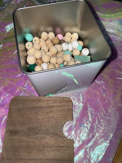 N/a Wooden beads- some painted . Metal box with lid included