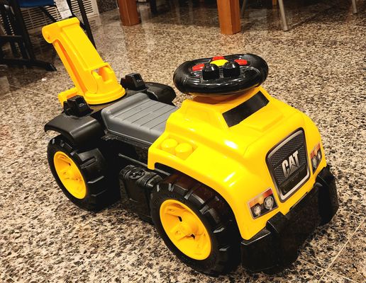 Mega Bloks CAT 3-in-1 ride-on toy. The steering wheel has controls that produce realistic truck soun
