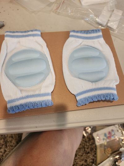 NEW blue baby knee pads protect crawling infants from bruises and scrapes.