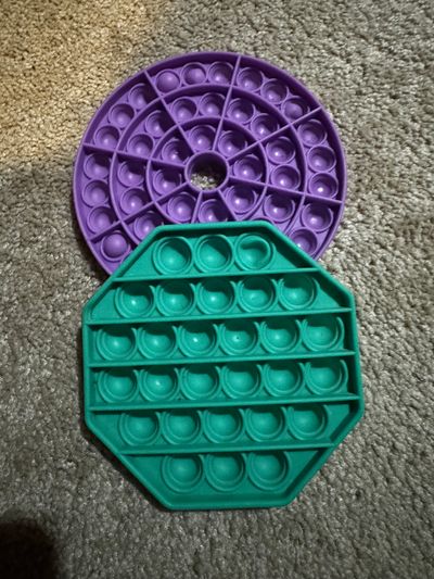 2 poppers 2 poppers. One round purple and one green octagon