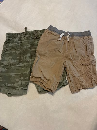 Oshkosh and carters size 6 2 pairs shorts 1 green camo with palm trees and 1 tan cargo 6T/6