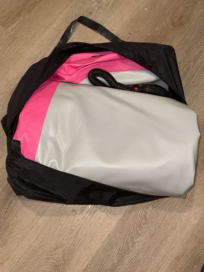 Pink and gray inflatable tumble mat About 10 to 13 feet long with pump and carrying bag included